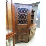 A oak corner unit with glazed and leaded door