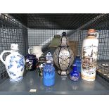 Cage containing ginger jars, gin bottle, table lamp, vases and various bottles