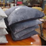 Stack of 4 grey cushions