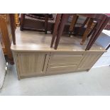 Contemporary oak finished sideboard with central drawers and doors to the side