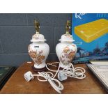 A pair of floral decorated table lamps