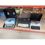 Silver reed electric typewriter and 2 vintage cased travelling typewriters