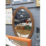 Oval beveled mirror in oak frame