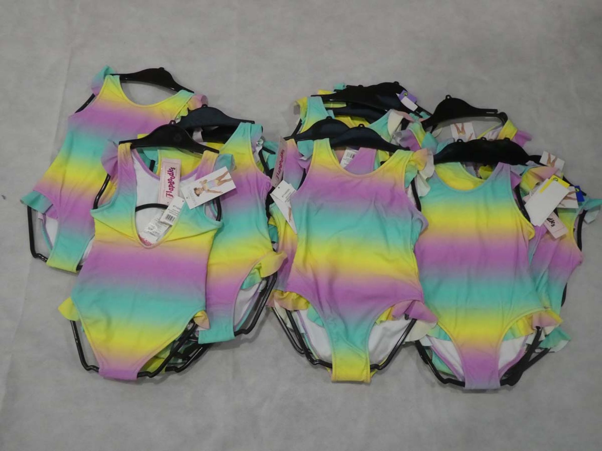 Selection of girl's Flapdoodles rainbow print swimming costumes in various sizes