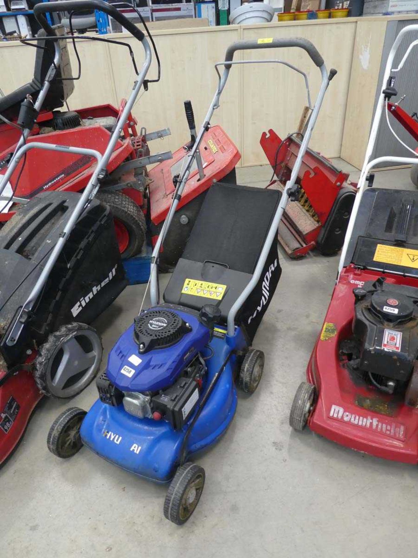 Hyundai blue petrol powered rotary mower with grass box