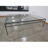 Large glass coffee table on metal supports