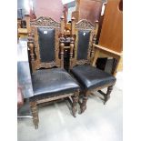 Pair of carved oak dining chairs with rexine seat and backrest