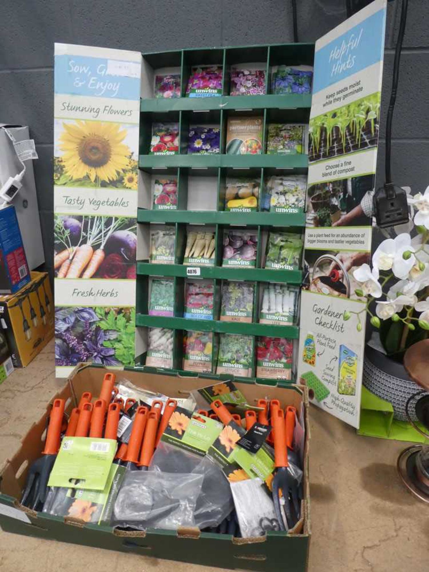 Tray of various plants, seeds, and a box of swivel hooks and forks