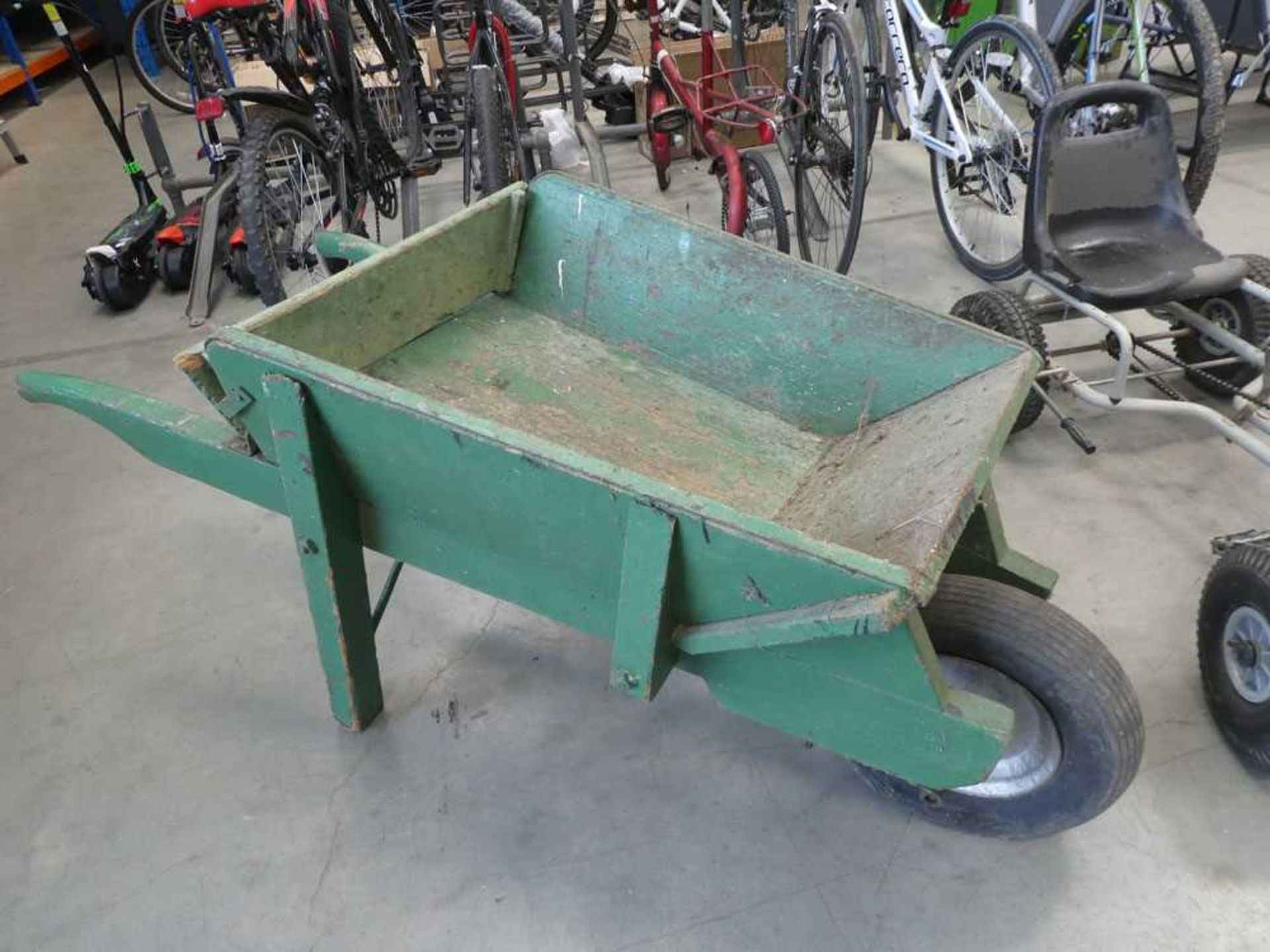 Green vintage single wheeled barrow