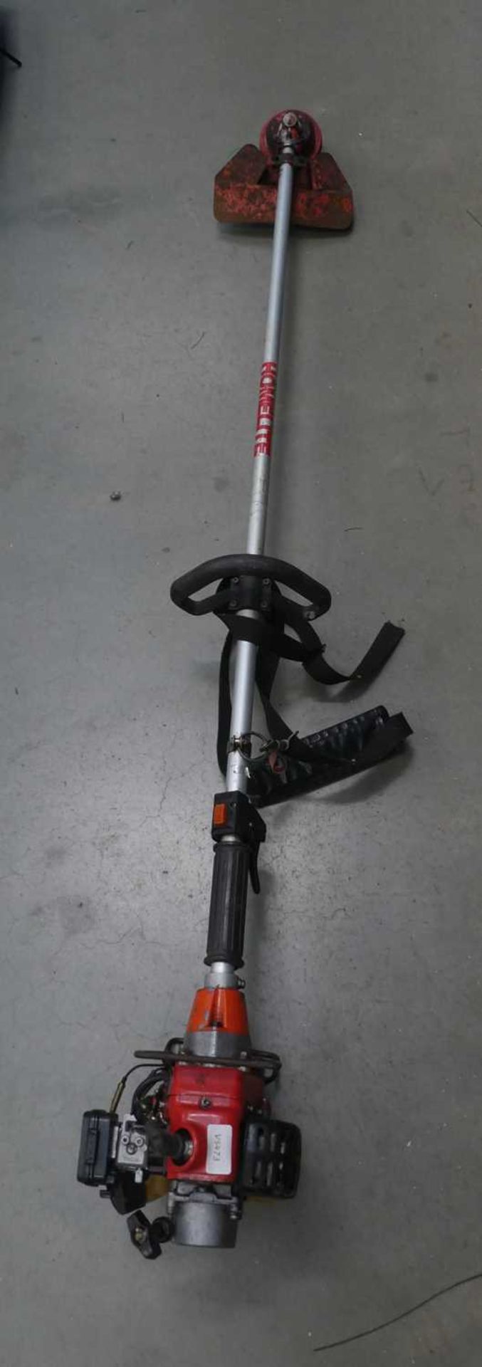 Red kawasaki petrol powered strimmer