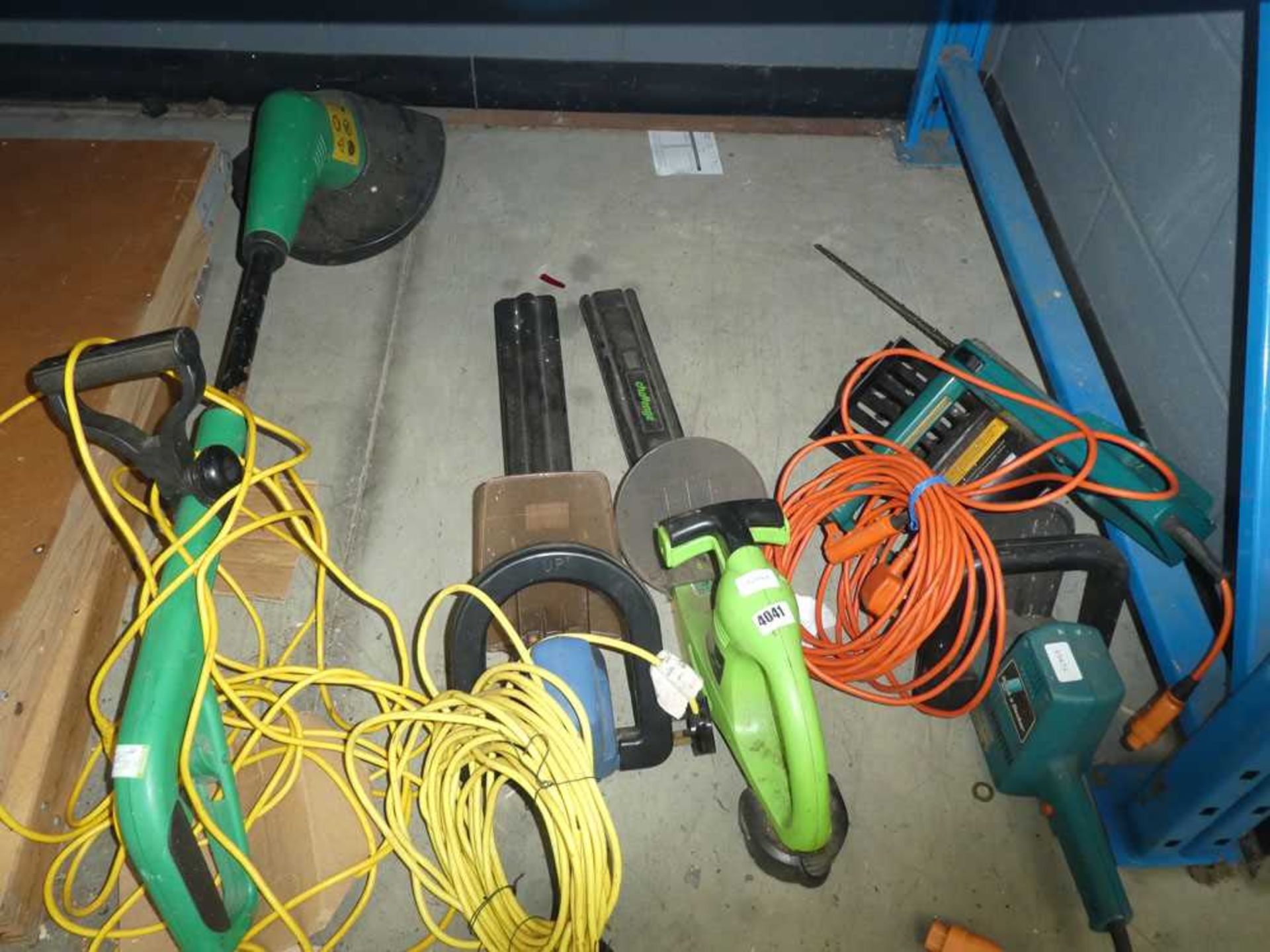 Small quantity of electric garden tools including strimmers, hedge cutters and chainsaw