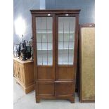 Glazed oak double door bookcase with cupboard under