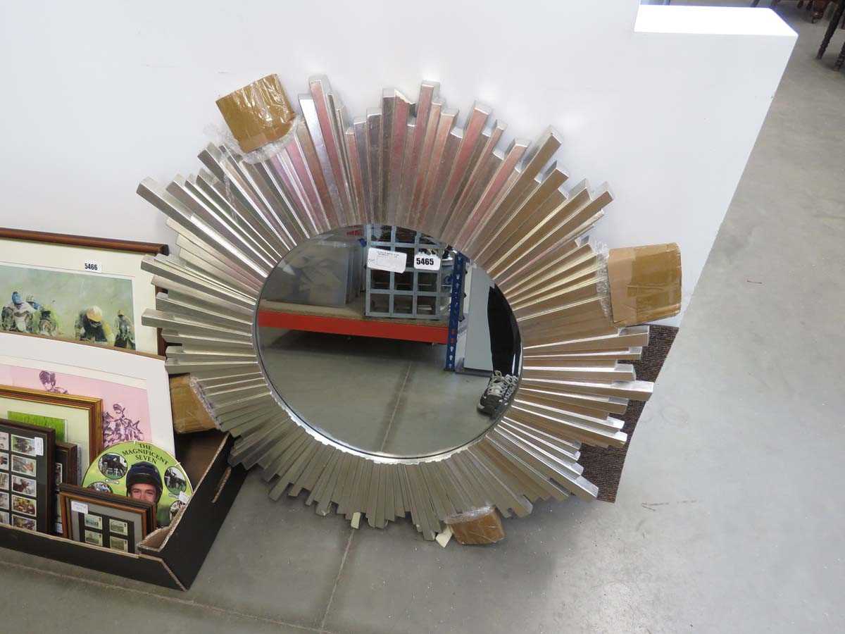 Circular mirror in silver sunburst frame