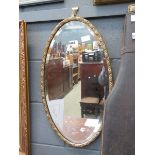 Oval bevelled mirror in floral frame