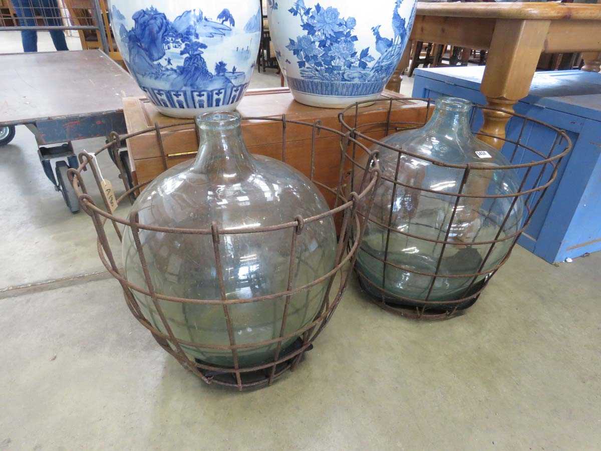 Pair of carbouys with metal cages