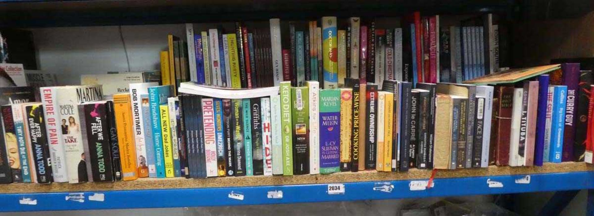 Shelf comprising hard back and paperback novels, autobiographies, etc.