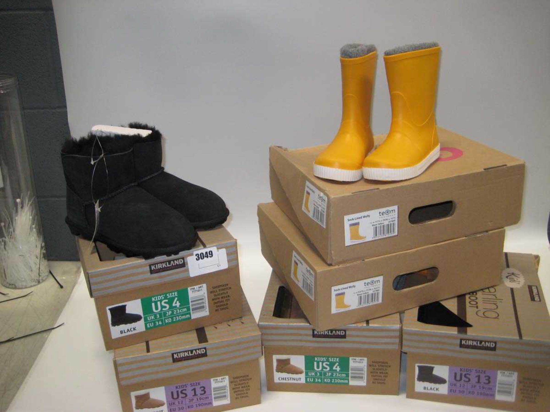 4 boxed pairs of Kirkland kids sheepskin boots and 2 boxed pairs of Wellingtons in yellow