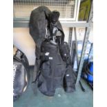 Black Made in USA golf bag containing mixed branded golf clubs