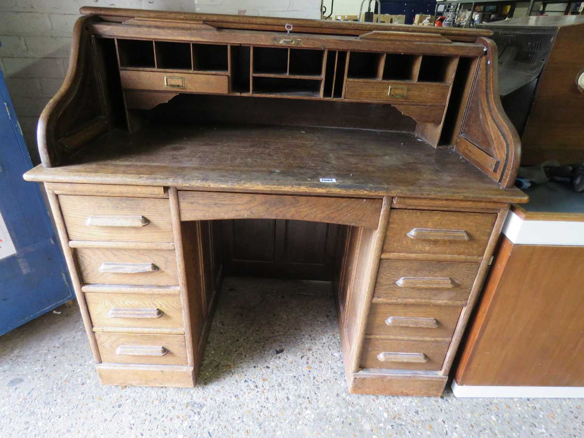 Oak roll top desk with integral storage with 8 drawers below