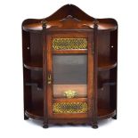 A late 19th/early 20th century oak corner smoker's cabinet with a glazed door