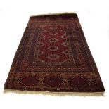 A Persian rug, the red ground with repeated motifs within matching borders, 250 x 130 cm