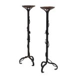 A pair of wrought iron writhen candlesticks, h. 68 cm each