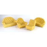 A pair of Sindy cream button two-seater sofas and a matching armchair, together with a similar