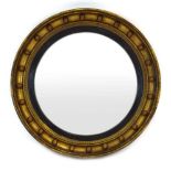 A Regency-style convex mirror with ebonised border in a beaded gilt frame with ball decoration, d.