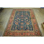+VAT A mid-20th century carpet with a rich red ground, foliate motifs and matching borders, 381 x