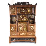 A 19th century Japanese cabinet of imposing proportions, intricately gilt decorated, carved and