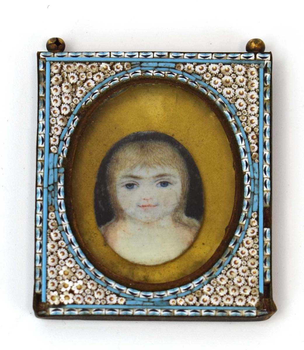 A miniature head and shoulders portrait of a young girl within a gilt metal and champlevé mount, 6 x