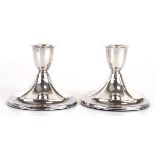 A pair of Danish silver dwarf candlesticks of oval form, h. 6 cm, loaded (2)