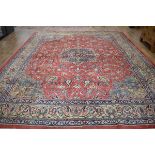 +VAT A modern carpet with a red ground, floral pattern and matching borders, 422 x 319 cm*Please