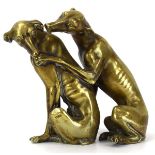 A bronze figural group modelled as a pair of greyhounds seated on hind quarters and preening,