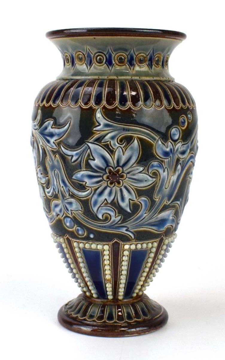 A Doulton Lambeth vase of ovoid form relief decorated with stylised flowers on a beaded blue/treacle