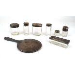 Seven early 20th century silver mounted dressing table bottles and a hand mirror, various dates