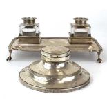 An early 20th century silver two bottle desk stand of rectangular form with gadrooned border on claw