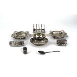 A mixed group of silver comprising a tea strainer and stand, a four slice toast rack, a golf club