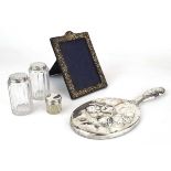 A mixed group of silver comprising an early 20th century hand mirror, a photograph frame and three