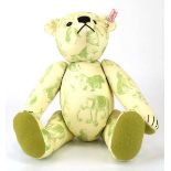 A limited edition Steiff fully jointed bear in pale green animal printed fabric, h. 30 cm