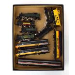 A group of N gauge locos comprising an American diesel loco and coach, a steam loco and tender, four