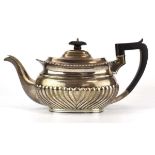 An early 20th century silver teapot of typical form with gadrooned decoration, Viners, Sheffield