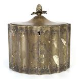 A George III silver tea caddy of reeded oval form with pineapple finial above and engraved body,