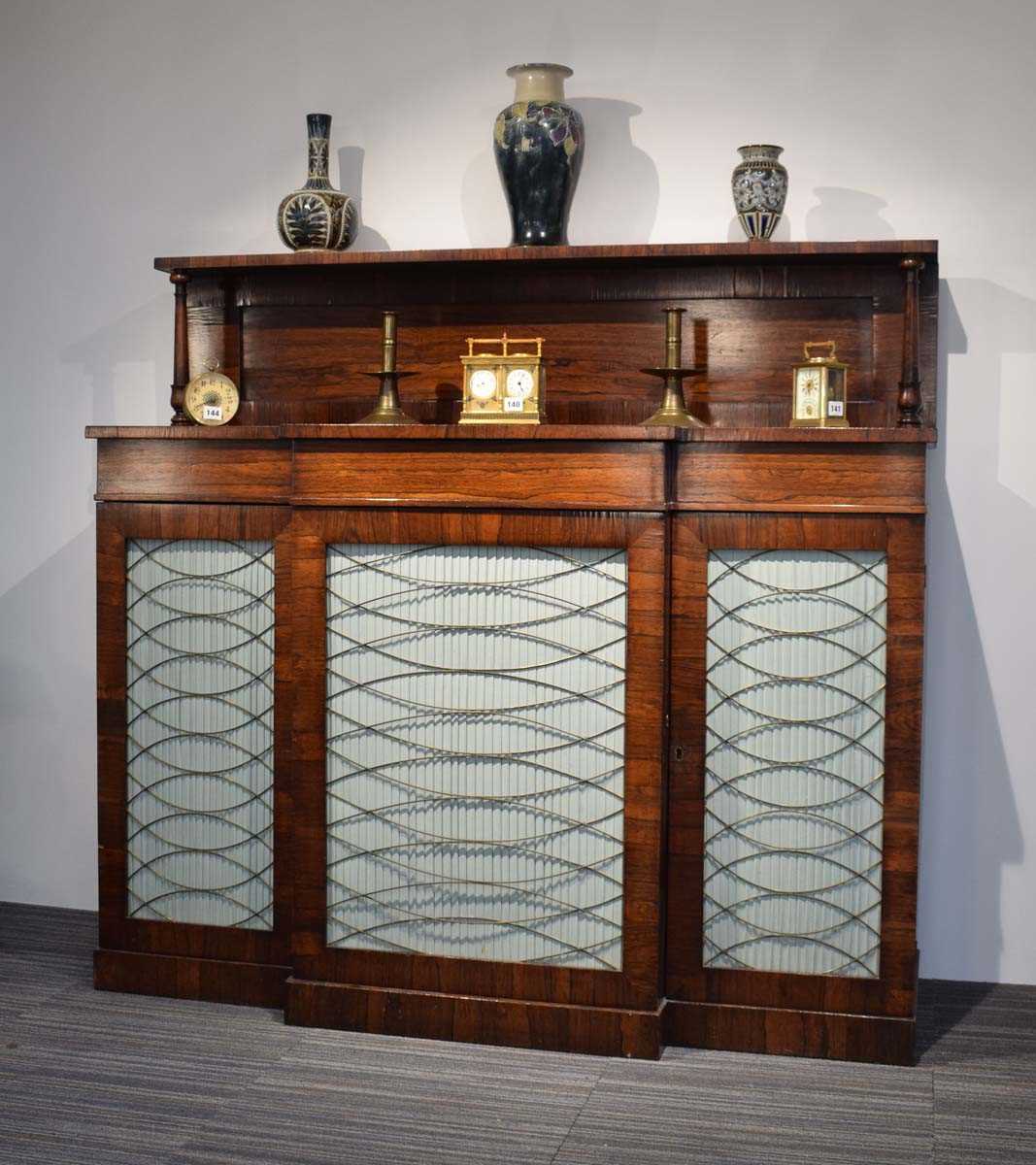 A Regency rosewood breakfast chiffonier, c. 1820, the superstructure over a breakfront with silk