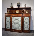 A Regency rosewood breakfast chiffonier, c. 1820, the superstructure over a breakfront with silk