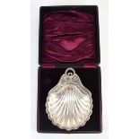 An Edwardian silver butter dish of shell form decorated in the Neo-Classical manner and having a