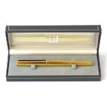 A cased Dunhill pen with a gold-plated body