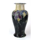 A Royal Doulton vase of baluster form, relief decorated with stylised flowers on a mottled green