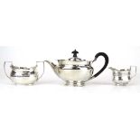 A Victorian silver teapot, maker HA, Sheffield 1898, together with a silver cream jug and a two