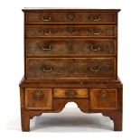 A George I/II walnut and oyster veneered chest-on-chest with an arrangement of four long graduated